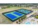 Overhead view of tennis courts surrounded by trees and lounge chairs near pool area at 8548 S Quatar St, Aurora, CO 80016