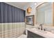 Bathroom with a vanity sink and a striped shower curtain at 309 S 30Th Ave, Brighton, CO 80601
