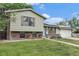 Charming split-level home with a well-maintained lawn and flower boxes adding curb appeal at 309 S 30Th Ave, Brighton, CO 80601
