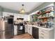 Modern kitchen with stainless steel appliances, bright white cabinetry, and trendy backsplash at 309 S 30Th Ave, Brighton, CO 80601