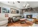 Cozy living room featuring a brick fireplace, hardwood floors, and comfortable seating at 309 S 30Th Ave, Brighton, CO 80601