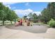 Community playground including swings, a slide, and climbing structures in a well maintained green space at 309 S 30Th Ave, Brighton, CO 80601