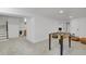 Finished basement features a foosball table, carpet and steps leading to another area at 1455 Hudson St, Denver, CO 80220