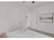Bright bedroom with a light gray accent wall features contemporary art and plush carpet at 1455 Hudson St, Denver, CO 80220