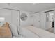Minimalist bedroom features a large closet and a comfortable bed with an oval mirror on the wall at 1455 Hudson St, Denver, CO 80220