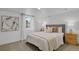Cozy bedroom featuring carpet, a comfy bed with throw pillows, and two bedside tables with lamps at 1455 Hudson St, Denver, CO 80220