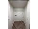 Inside a minimalist closet space with wooden floors, white walls and a wire rack on the wall at 1455 Hudson St, Denver, CO 80220
