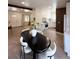Open-concept dining room featuring modern furnishings, wood floors, and seamless transition to the kitchen and living areas at 1455 Hudson St, Denver, CO 80220