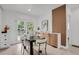 Dining room with designer wood accent wall, seating for four, and french doors to the yard at 1455 Hudson St, Denver, CO 80220