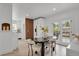 Dining area featuring modern chairs, dark table, and natural light, adjacent to the kitchen at 1455 Hudson St, Denver, CO 80220