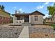 Bungalow exterior featuring a well-manicured lawn, stone mulch, and a welcoming front porch at 1455 Hudson St, Denver, CO 80220