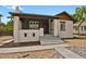 Charming bungalow with a painted brick exterior, covered porch, and well-maintained landscaping at 1455 Hudson St, Denver, CO 80220
