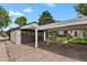 Brick two-car garage and carport with a concrete driveway on a sunny day at 1455 Hudson St, Denver, CO 80220
