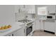 Modern kitchen featuring white cabinets, gold fixtures, stainless steel appliances, and ample counter space at 1455 Hudson St, Denver, CO 80220