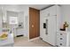Modern white kitchen with wood accents, stainless steel appliances, and quartz countertops at 1455 Hudson St, Denver, CO 80220