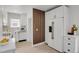 Clean white kitchen with modern appliances and stylish wooden accent wall at 1455 Hudson St, Denver, CO 80220