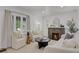 Inviting living room with a fireplace, modern furniture, and an abundance of natural light at 1455 Hudson St, Denver, CO 80220