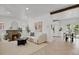 Bright living room with a fireplace, herringbone floors, and an open concept to the kitchen at 1455 Hudson St, Denver, CO 80220