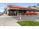 Exterior of Marczyk Fine Foods store with awnings, brick facade and glass front doors at 1455 Hudson St, Denver, CO 80220
