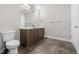 Bathroom boasts a double sink vanity with dark wood cabinets, complemented by dark tiled flooring and bright lighting at 20 Wilcox St # 318, Castle Rock, CO 80104