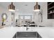 Modern kitchen featuring stainless steel sink, white countertops, contemporary lighting, and an open-concept design at 20 Wilcox St # 318, Castle Rock, CO 80104