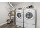 This laundry area includes washer, dryer, water heater, and plenty of shelving for cleaning and laundry supplies at 20 Wilcox St # 318, Castle Rock, CO 80104