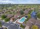 An aerial view of homes showcasing mature trees, a pond, and a community pool area at 2800 S University Blvd # 184, Denver, CO 80210