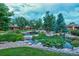 Tranquil pond with decorative rock borders, a small waterfall and lush landscaping at 2800 S University Blvd # 184, Denver, CO 80210