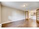 Bedroom with wood-look flooring and French doors leading to the bathroom at 1300 S Parker Rd Rd # 210, Denver, CO 80231