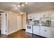 White kitchen with granite countertops and modern appliances at 1300 S Parker Rd Rd # 210, Denver, CO 80231