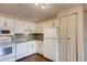 White kitchen with granite countertops and modern appliances at 1300 S Parker Rd Rd # 210, Denver, CO 80231