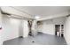 Utility room in the basement with a furnace, shelving, and painted gray concrete floors at 4430 S Cherokee St, Englewood, CO 80110