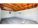 Unfinished basement with exposed wood beams, concrete floors, and natural light at 4430 S Cherokee St, Englewood, CO 80110