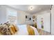 Bright bedroom featuring hardwood floors, white walls, and a mirrored wardrobe at 4430 S Cherokee St, Englewood, CO 80110