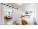 Cozy bedroom with hardwood floors and a sliding barn door leading to the main living area at 4430 S Cherokee St, Englewood, CO 80110