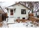 Charming single-story home with a white exterior, black trim, and a cozy front entrance at 4430 S Cherokee St, Englewood, CO 80110