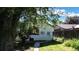 Home exterior showing side yard and garden, with healthy plantings under a sunny, blue sky at 4430 S Cherokee St, Englewood, CO 80110