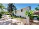 Home exterior showing side yard and garden, with healthy plantings under a sunny, blue sky at 4430 S Cherokee St, Englewood, CO 80110