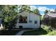 Home exterior showing side yard and garden, with healthy plantings under a sunny, blue sky at 4430 S Cherokee St, Englewood, CO 80110