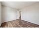 Clean bedroom with wood-look flooring and an open doorway to the bathroom at 5218 E 100Th Pl, Thornton, CO 80229