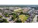 An aerial view of a suburban community with townhomes and well-maintained landscaping on a sunny day at 1245 S Willow St, Denver, CO 80247