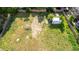 A spacious backyard with green grass, bordered by brick walls and mature trees, featuring a storage shed at 1245 S Willow St, Denver, CO 80247