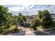 Charming home surrounded by lush trees, with a fenced yard and inviting driveway at 1245 S Willow St, Denver, CO 80247
