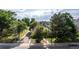 Cozy home nestled among mature trees, featuring a fenced front yard and long driveway at 1245 S Willow St, Denver, CO 80247