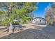 View of the home's backyard with mature trees and partial fencing at 101 S 11Th Ave, Brighton, CO 80601