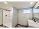 Modern bathroom with walk-in shower, tiled floor, new vanity and great natural light at 101 S 11Th Ave, Brighton, CO 80601