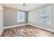 Bedroom featuring wood-look flooring, fresh paint and new light fixture at 101 S 11Th Ave, Brighton, CO 80601