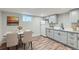 Cozy eat-in kitchen with gray cabinets, stainless steel appliances, and wood-look vinyl flooring at 101 S 11Th Ave, Brighton, CO 80601