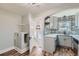 Charming kitchenette featuring designer tile backsplash, white countertops and grey cabinetry at 101 S 11Th Ave, Brighton, CO 80601