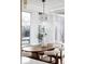 Bright dining room with a modern light fixture and a wooden table at 1459 S Filbert Way, Denver, CO 80222